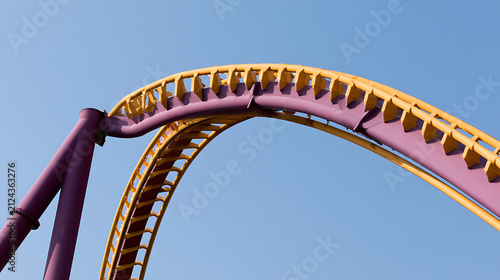 Vibrant Yellow and Purple Roller Coaster Track Against a Clear Blue Sky, Capturing the Thrill and Excitement of an Amusement Park Ride