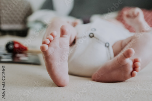Little foot of a cute baby with selective focus. Adorable one month newborn boy