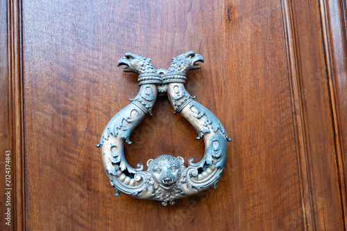 Obraz na płótnie Artisan-made  brass or bronze door knockers, antique object, close up