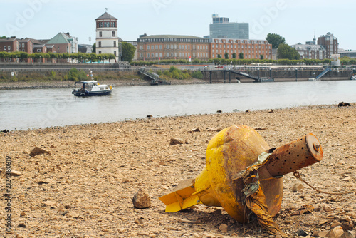 Düsseldorf, Germany,low stream gauge of rhine river.Water shortage, environmental catastrophe, climate change,global warming concept. Due to the drought buoys are on dry land.