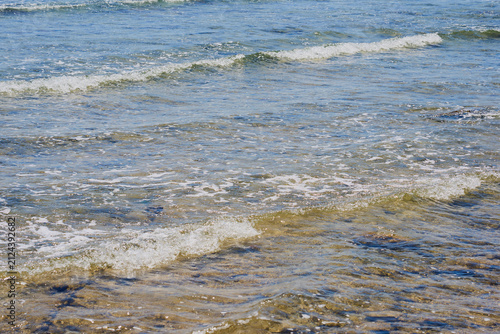 Crystal Clear Shallow Sea Water with Gentle Waves Over Rocky Seabed, Tropical Coastal Background