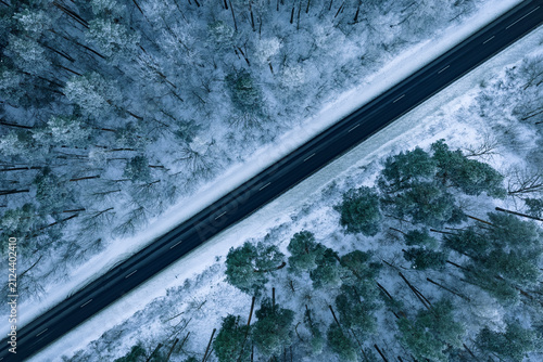 Aerial view of road and forest during snowy winter
