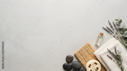 a wooden cutting board with a bunch of lavender flowers and a bottle of essential oil