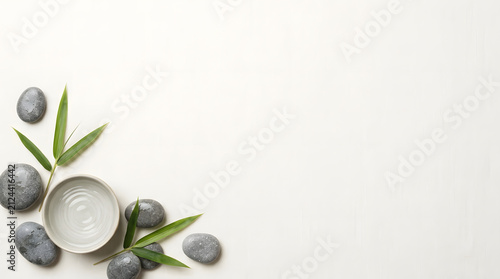 a white bowl with some rocks and a green leaf