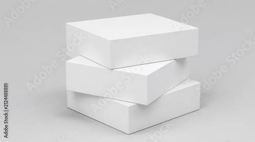 White rectangular gift boxes stacked unevenly against a neutral gray background