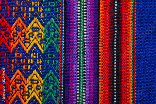 Colorful Peruvian woven striped textile with geometric strips and traditional pattern