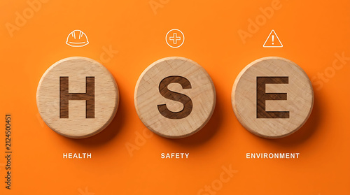 HSE Health Safety Environment acronym wooden block concept on orange