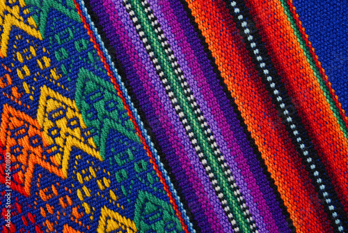 Colorful woven Andean striped textile with geometric strips