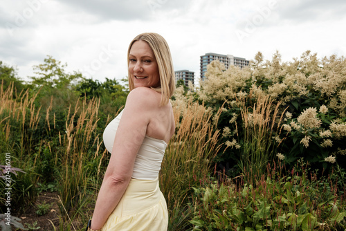 Photography Woman smiling in urban park with tall grass