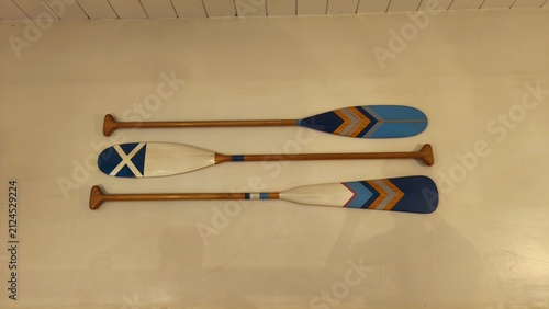 Quadro su tela Wooden decorative oar mounted on a textured white wall, interior design studio s