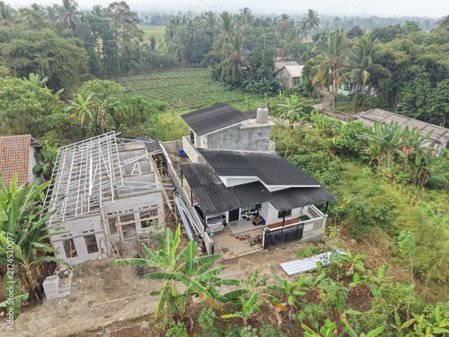 Aerial View of Rural Home Construction Amidst Lush Greenery