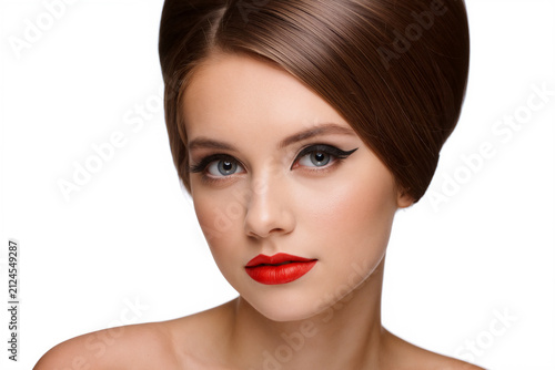 Woman with vintage beehive hairstyle and bold winged eyeliner with red lips on white background. Generative AI