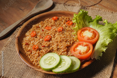 Canvas Print Fried rice on the wooden plate and wooden table with rustic concept