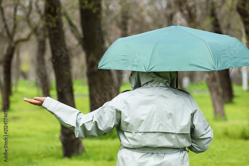 Woman with raincoat and gre...