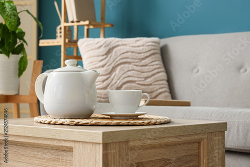 Teapot and cup of tea on wo...