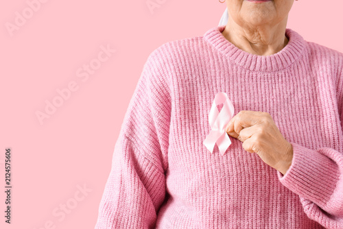Senior woman with pink ribb...