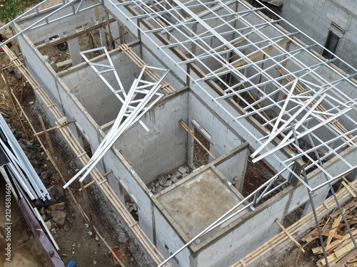 Metal Truss Roof Installation on Under Construction Building