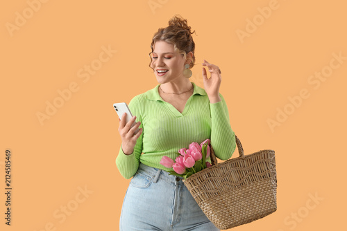 Pretty young woman holding ...