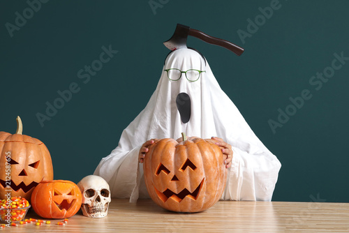 Ghost with carved Halloween...