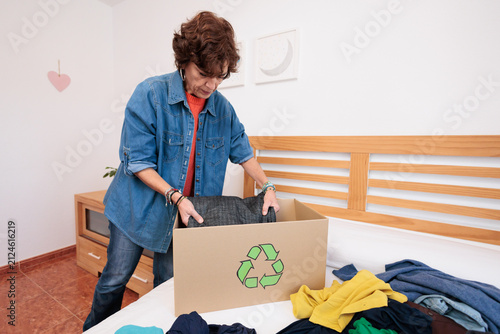 Woman preparing clothes for recycling and donating