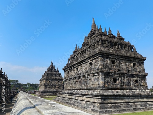 Bild auf Leinwand Ancient stone temple stands tall against clear blue sky