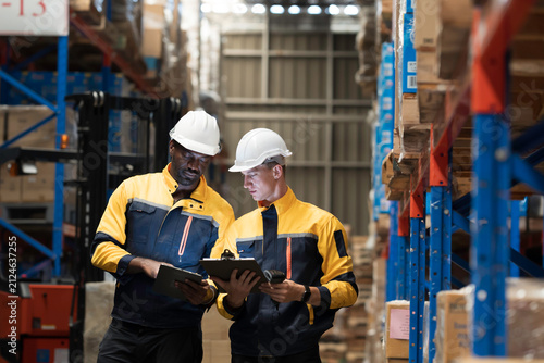 Team of warehouse worker manage inventory, process incoming and outgoing stock, organizes and fulfill orders inside storage or distribution facility