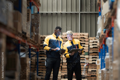 Картината върху платно Team of warehouse worker manage inventory, process incoming and outgoing stock,