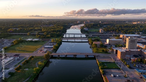 Scenic aerial flight over Genesee River in downtown Rochester New York at sunset