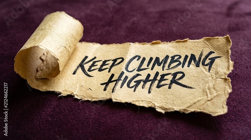 Foto Torn parchment paper saying keep climbing higher