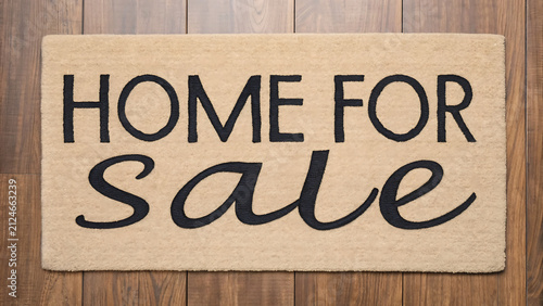 Real estate for sale sign on rustic wooden door. Chalkboard home listing with handwritten property announcement.