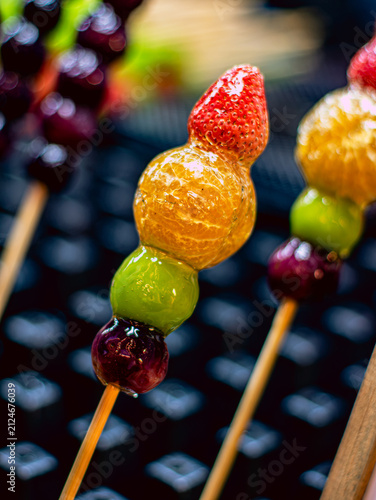 Macro Close Up of Candied Fruit Skewer with Strawberry Orange and Grape
