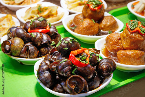 Photography Traditional Shanghai dishes of spicy river snails and braised meatballs served i