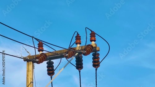 Thai power pole with cables generator under clear blue sky Thailand.