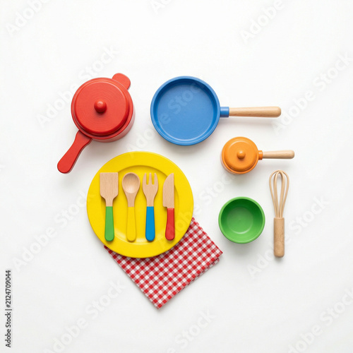 Colorful toy kitchen utensils on checkered napkin background  