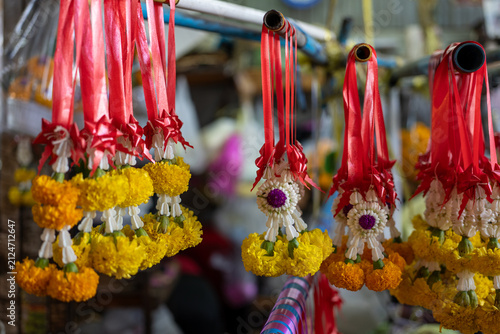 Bild auf Leinwand Thai Jasmine and Marigold Garlands Hanging on Display, Surat Thani, Thailand