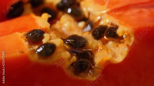 Close-up of ripe papaya flesh and glossy black seeds, showcasing the vibrant orange color and natural texture of this tropical fruit. Rich in vitamins, antioxidants, and dietary fiber, the image is id
