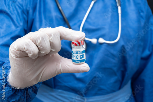 GHK-CU peptide vial held by a clinical professional for medical research