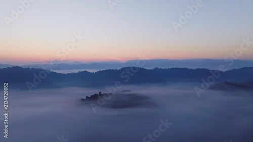 Amazing sunrise with fog move flowing over mountains,Sunrise sky,Aerial view Drone flies over clouds,Rainforest Clouds and fog in sunrise light, Nature and travel background