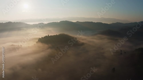 Amazing sunrise with fog move flowing over mountains,Sunrise sky,Aerial view Drone flies over clouds,Rainforest Clouds and fog in sunrise light, Nature and travel background