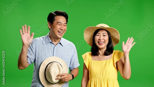 Joyful Couple Celebrating Beach Vacation Against Vibrant Green Screen Background Perfect for Travel and Holiday Themes
