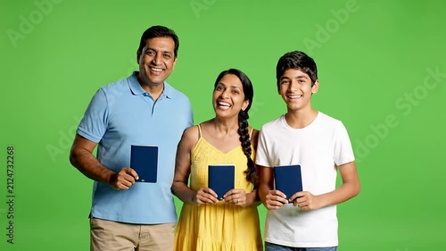 Joyful Family Celebrating Travel Documents Ready Against Bright Green Screen in a Studio Setting