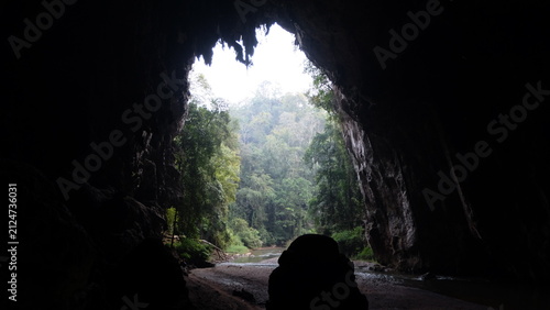 Bild auf Leinwand Bamboo raft passing along natural lake in limestone cave