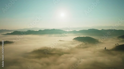 Amazing sunrise with fog move flowing over mountains,Sunrise sky,Aerial view Drone flies over clouds,Rainforest Clouds and fog in sunrise light, Nature and travel background