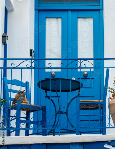 фотографія Charming blue balcony in Naxos, Greece with a cat relaxing in the sunshine