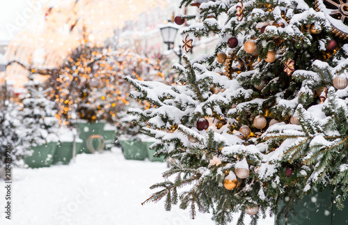 A beautiful Christmas background. The concept of decorations and decor for the New Year 2027. Christmas trees on the streets of Moscow with festive decorations in the snow.