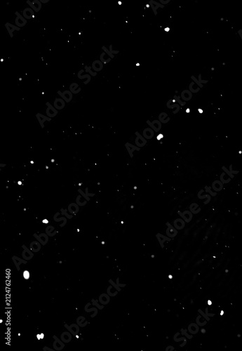 Bild auf Leinwand Snowflakes falling on dark black background, isolated winter effect texture