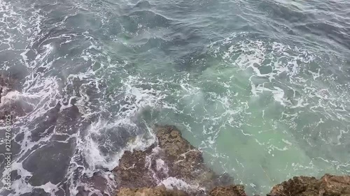Calm waves at a beach with blue water