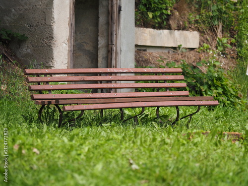 Brown wooden bench and concrete entrance
