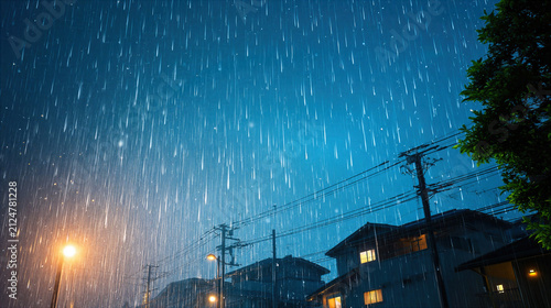 Heavy rain at night with illuminated houses and streetlights in urban neighborhood