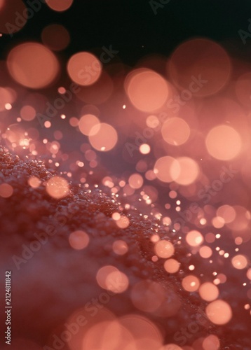 Abstract background with a dark red color. the background is filled with small, circular lights that are blurred and appear to be floating in the air.